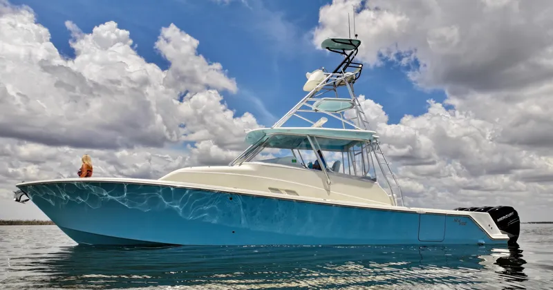 Saltwater Striker Yacht Photos Pics 2016 SeaVee 430 Fish Around boat on water under cloudy sky.