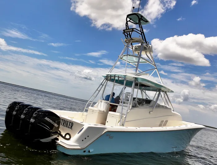 Saltwater Striker Yacht Photos Pics 2016 SeaVee 430 Fish Around boat with multiple outboard motors on a sunny day.