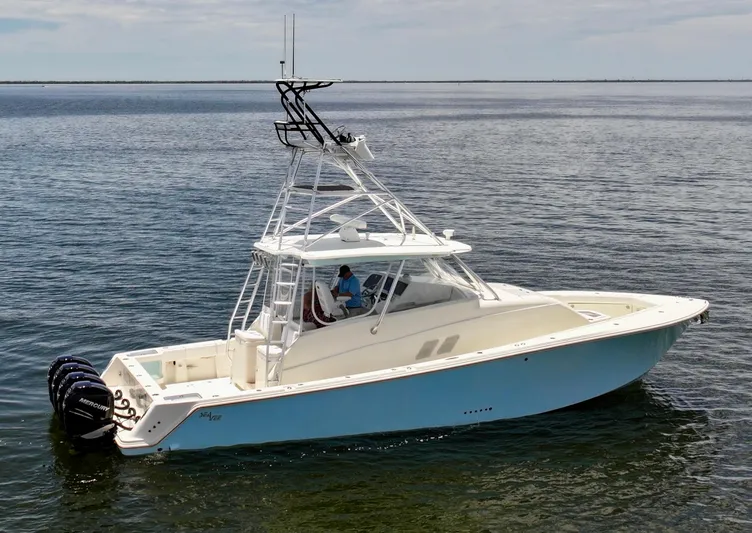 Saltwater Striker Yacht Photos Pics 2016 SeaVee 430 Fish Around boat on calm water, featuring a sleek design and multiple engines.