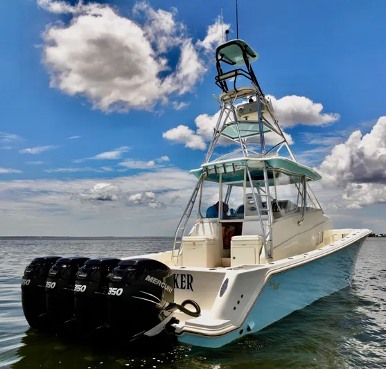 Saltwater Striker Yacht Photos Pics 2016 SeaVee 430 Fish Around boat with triple Mercury engines on calm water.