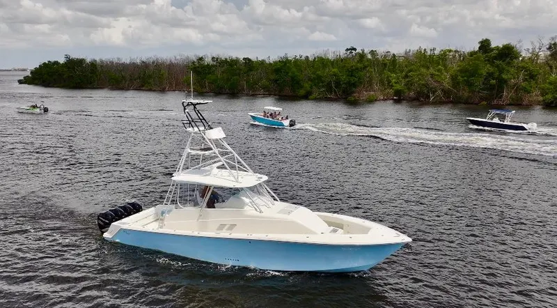 Saltwater Striker Yacht Photos Pics 2016 SeaVee 430 Fish Around boat cruising on a river with other boats nearby.