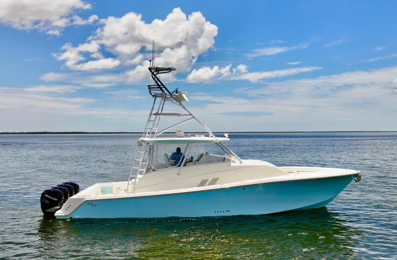 Saltwater Striker Yacht Photos Pics 2016 SeaVee 430 Fish Around boat on calm water under a blue sky.