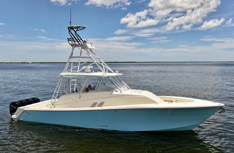 Saltwater Striker Yacht Photos Pics 2016 SeaVee 430 Fish Around boat on calm water under a partly cloudy sky.