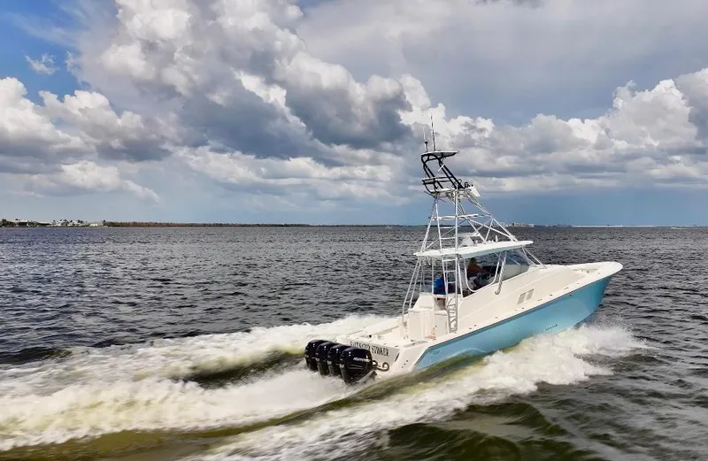 Saltwater Striker Yacht Photos Pics 2016 SeaVee 430 Fish Around boat cruising on open water under cloudy skies.