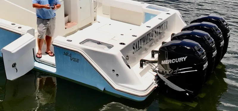 Saltwater Striker Yacht Photos Pics 2016 SeaVee 430 Fish Around boat with triple Mercury engines on water.