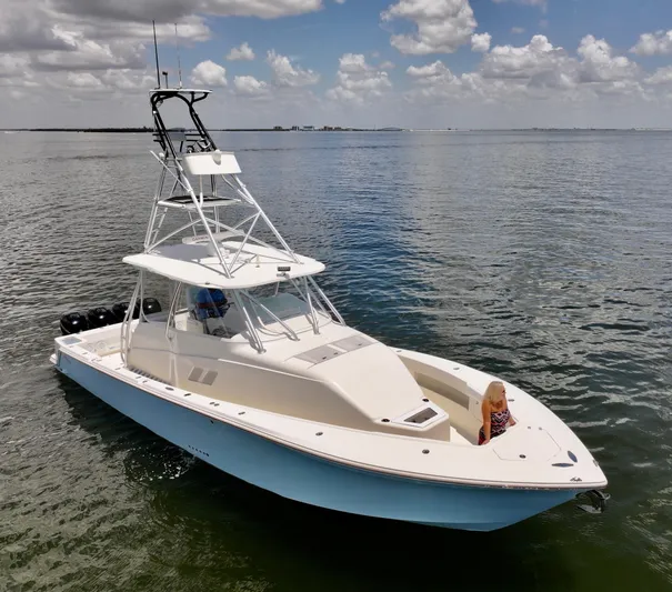 Saltwater Striker Yacht Photos Pics 2016 SeaVee 430 Fish Around boat on calm water under a partly cloudy sky.
