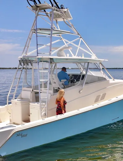Saltwater Striker Yacht Photos Pics 2016 SeaVee 430 Fish Around boat on water with two people onboard.