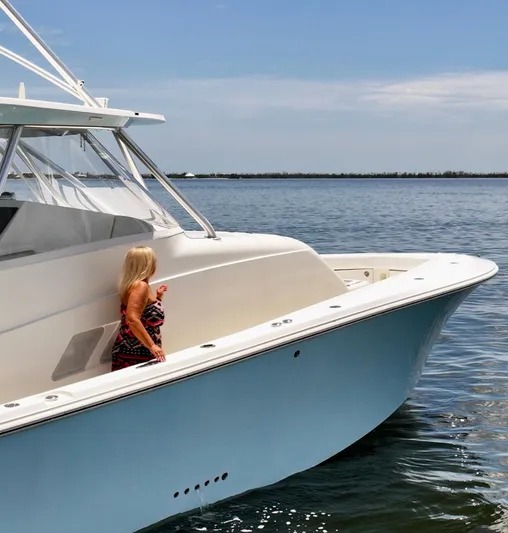 Saltwater Striker Yacht Photos Pics 2016 SeaVee 430 Fish Around boat on calm water with a person on deck.