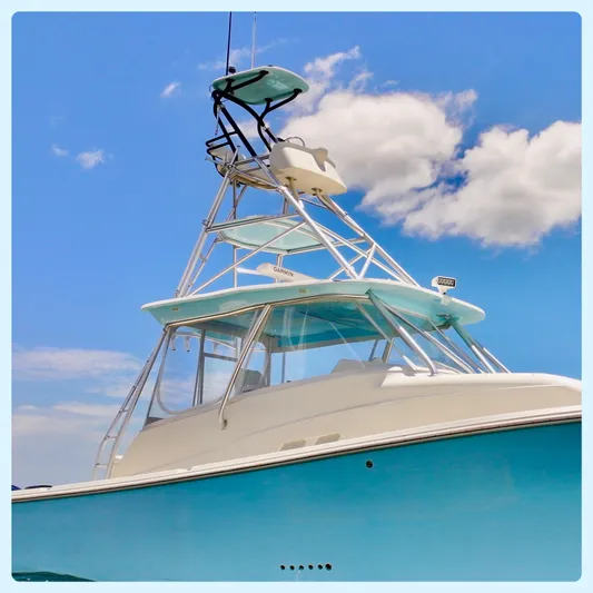 Saltwater Striker Yacht Photos Pics 2016 SeaVee 430 Fish Around boat against a bright blue sky with clouds.
