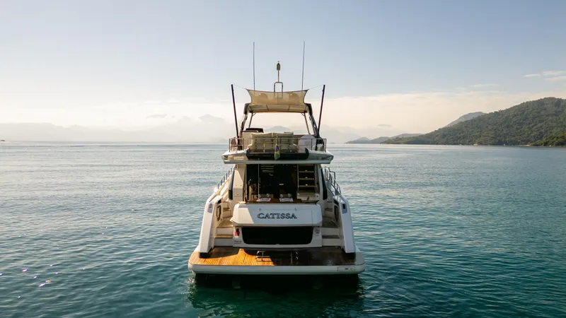 Catissa Yacht Photos Pics 2024 Ferretti Yachts 670 on serene water with scenic mountain backdrop.