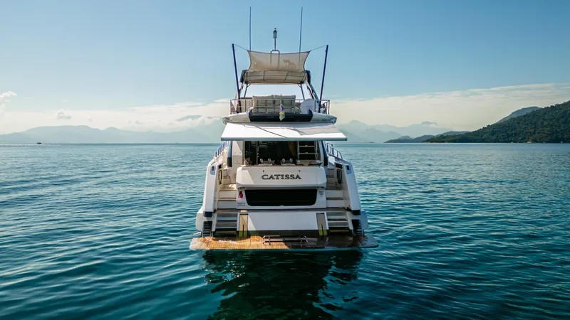 Catissa Yacht Photos Pics 2024 Ferretti Yachts 670 on serene water with scenic mountain backdrop.