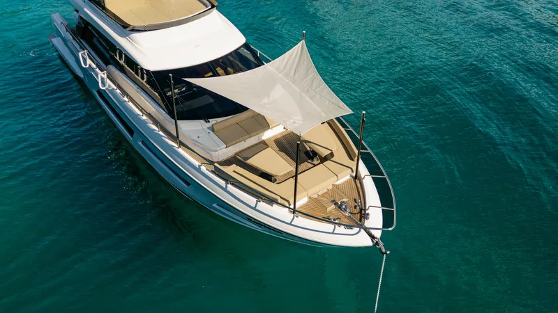 Catissa Yacht Photos Pics 2024 Ferretti Yachts 670 anchored in clear blue water, featuring a sunshade on deck.