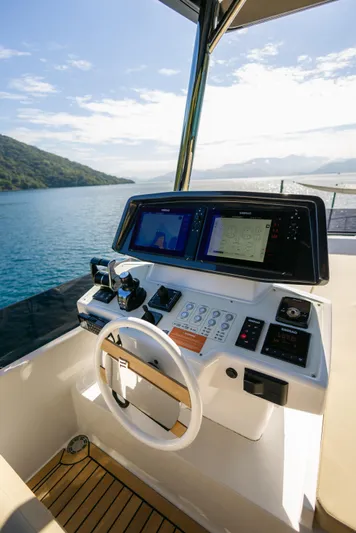 Catissa Yacht Photos Pics Helm of 2024 Ferretti Yachts 670 with advanced navigation systems, overlooking serene waters.