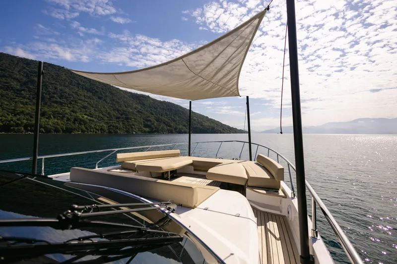 Catissa Yacht Photos Pics Luxurious 2024 Ferretti Yachts 670 with sunshade, cruising on serene waters.