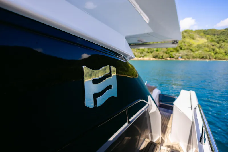 Catissa Yacht Photos Pics 2024 Ferretti Yachts 670, sleek design, docked by clear blue water.