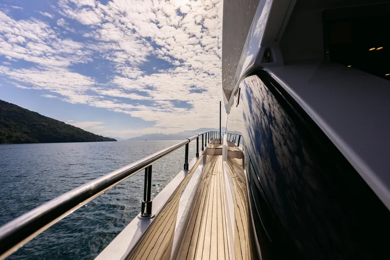 Catissa Yacht Photos Pics Side view of 2024 Ferretti Yachts 670 on serene water with scenic backdrop.