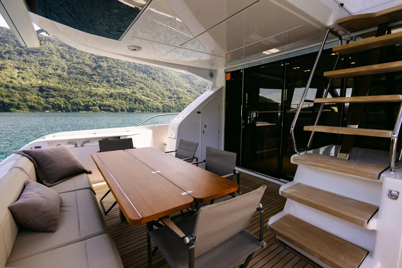 Catissa Yacht Photos Pics Luxurious 2024 Ferretti Yachts 670 deck with elegant seating and scenic water view.