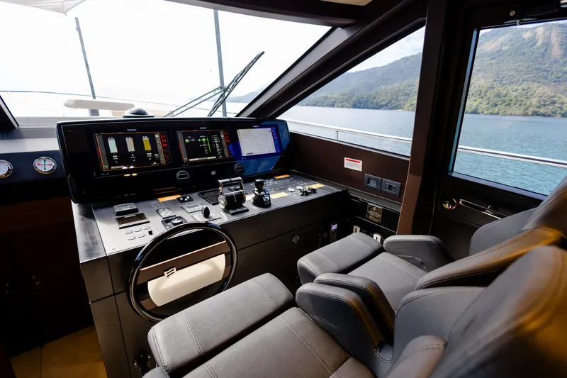 Catissa Yacht Photos Pics 2024 Ferretti Yachts 670 helm with advanced navigation controls and scenic ocean view.