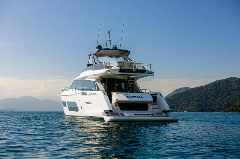 Catissa Yacht Photos Pics 2024 Ferretti Yachts 670 on serene water with scenic mountain backdrop.