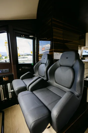 Catissa Yacht Photos Pics Luxurious interior seating of 2024 Ferretti Yachts 670, featuring sleek black leather chairs.