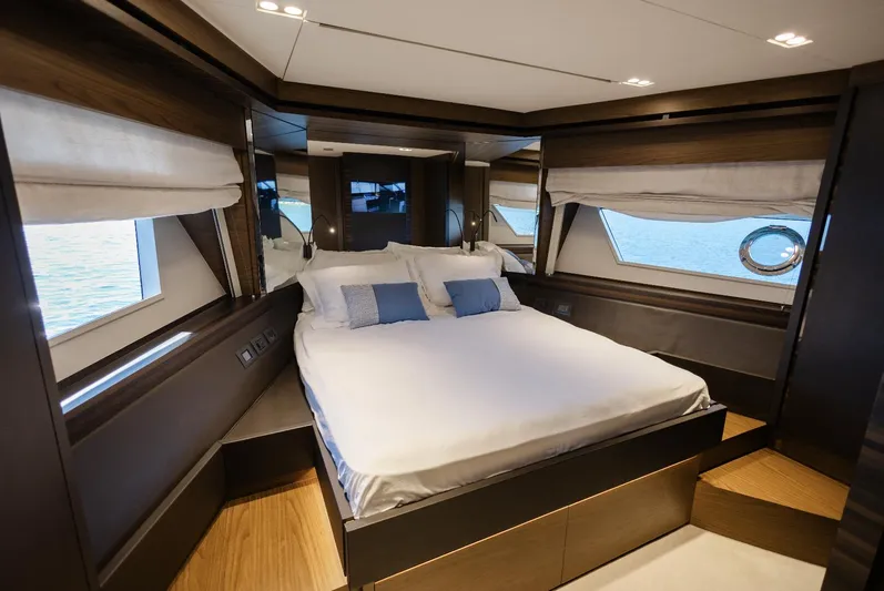 Catissa Yacht Photos Pics Luxurious bedroom interior of 2024 Ferretti Yachts 670 with elegant wood finishes and ocean view.