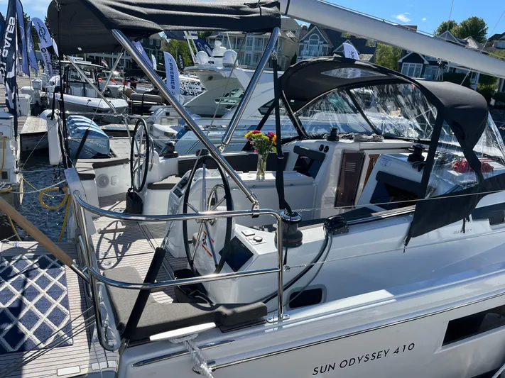  Yacht Photos Pics 2024 Jeanneau Sun Odyssey 410 sailboat docked, featuring dual steering wheels and sleek design.