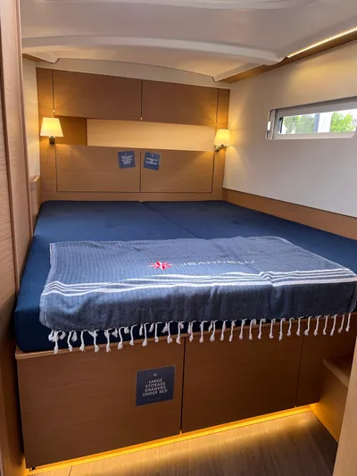  Yacht Photos Pics 2024 Jeanneau Sun Odyssey 410 cabin with cozy bed and ambient lighting.