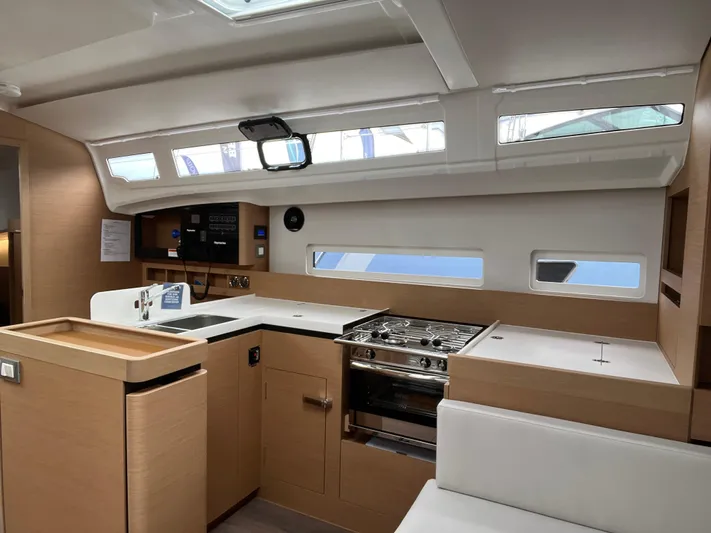  Yacht Photos Pics 2024 Jeanneau Sun Odyssey 410 interior kitchen with modern design and ample natural light.