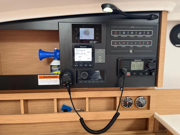  Yacht Photos Pics Control panel of 2024 Jeanneau Sun Odyssey 410 sailboat with navigation and communication equipment.