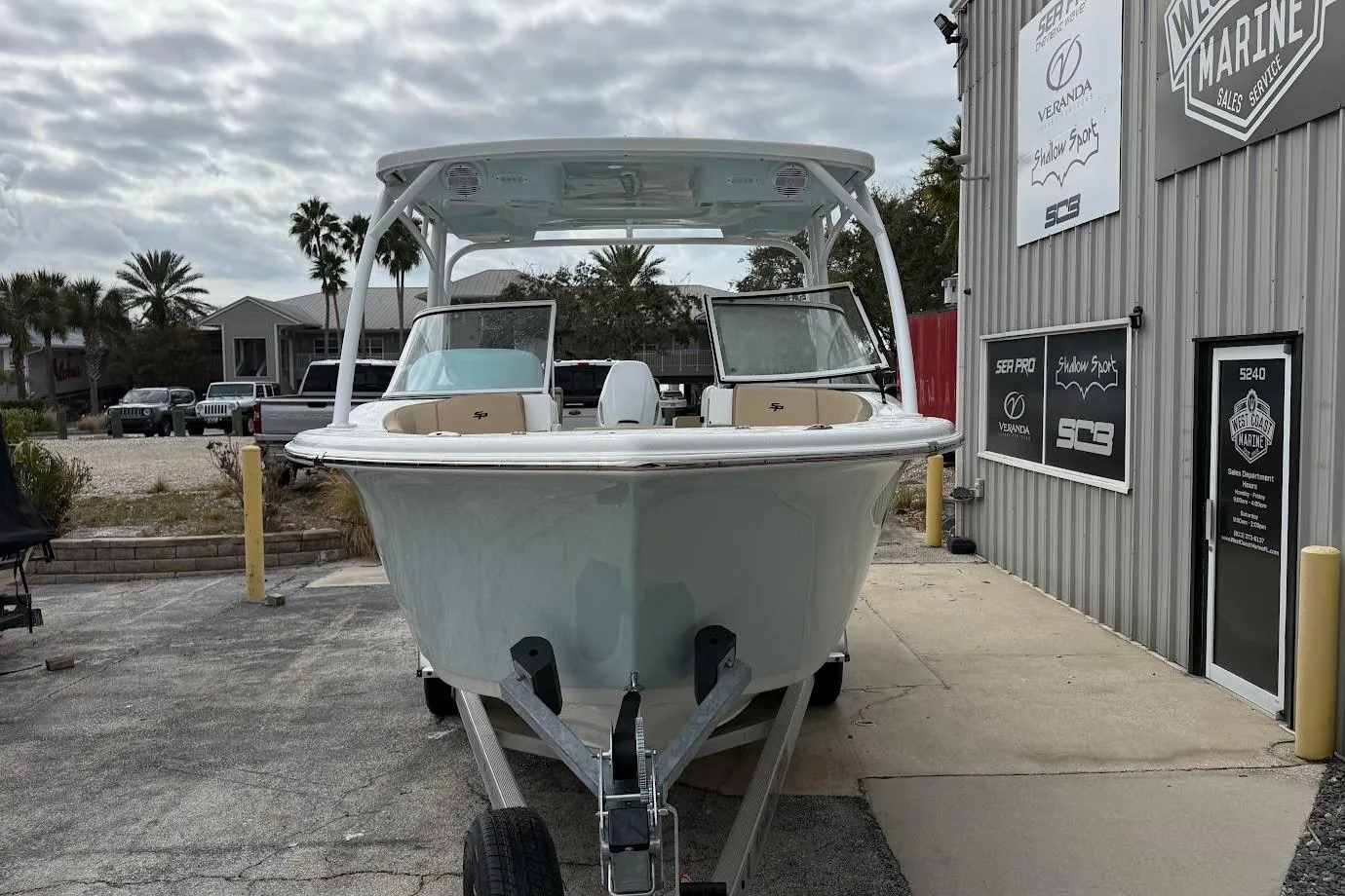 2026 Sea Pro 240 Dual Console boat parked outside a marine service shop.