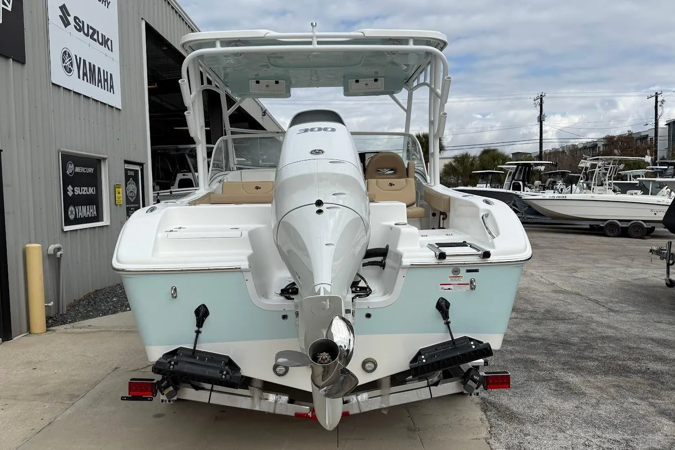 2026 Sea Pro 240 Dual Console boat with powerful outboard motor, parked at a dealership.