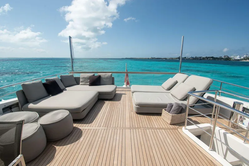 Muma Yacht Photos Pics Luxurious Sanlorenzo SL96 yacht deck with plush seating, overlooking turquoise ocean waters.