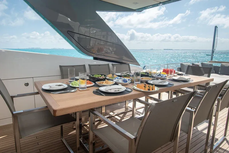 Muma Yacht Photos Pics Luxurious dining setup on 2016 Sanlorenzo SL96 yacht, overlooking serene ocean views.