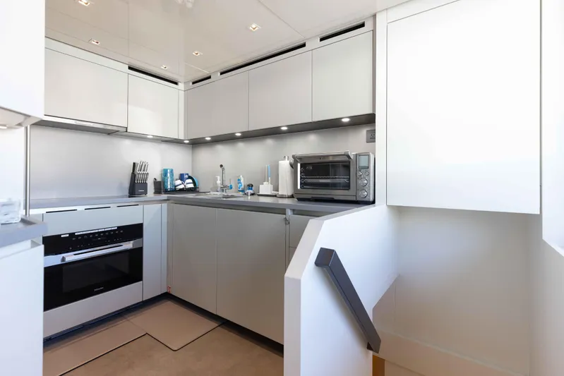 Chameleon Yacht Photos Pics Modern kitchen interior on 2024 Sanlorenzo SL90A yacht, featuring sleek cabinetry and appliances.