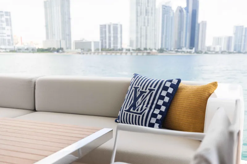 Chameleon Yacht Photos Pics Luxurious seating on 2024 Sanlorenzo SL90A yacht with city skyline view.