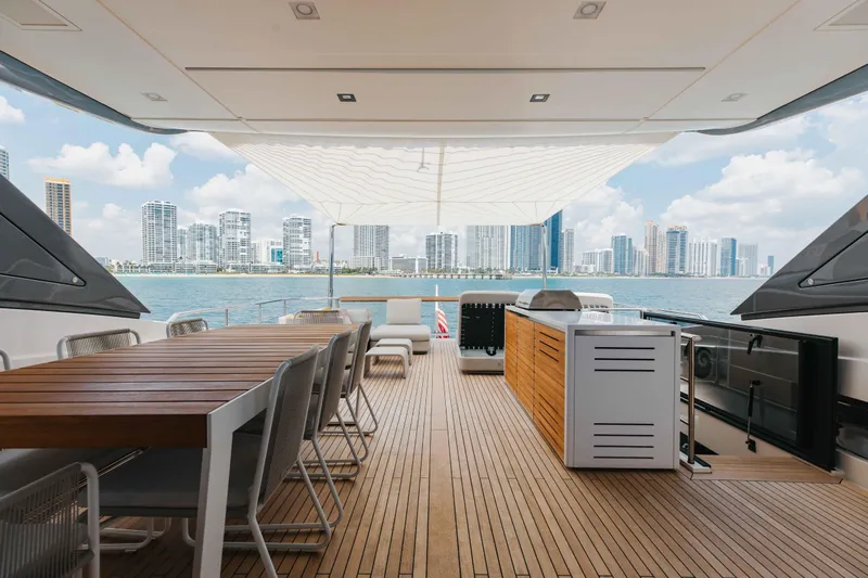 Chameleon Yacht Photos Pics Luxurious 2024 Sanlorenzo SL90A yacht deck with city skyline view.