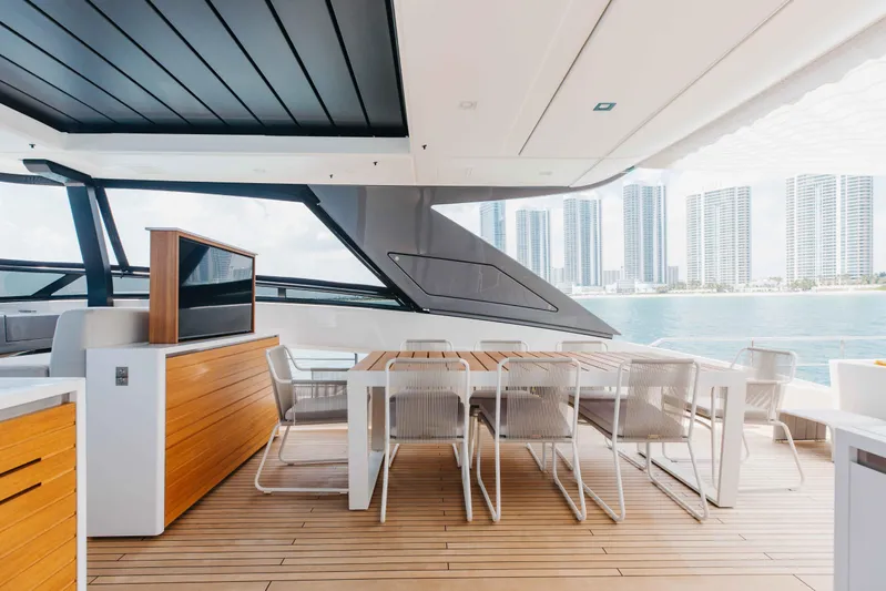 Chameleon Yacht Photos Pics Luxurious 2024 Sanlorenzo SL90A yacht deck with modern dining area and ocean view.