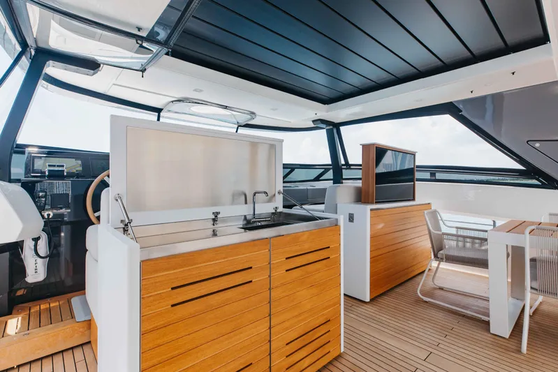 Chameleon Yacht Photos Pics Luxurious 2024 Sanlorenzo SL90A yacht interior with modern kitchen and dining area.