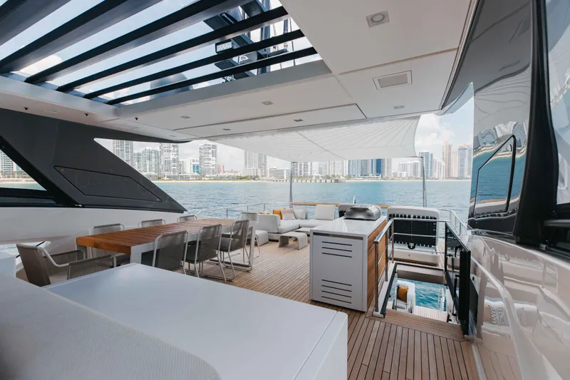 Chameleon Yacht Photos Pics Luxurious 2024 Sanlorenzo SL90A yacht deck with modern seating and city skyline view.