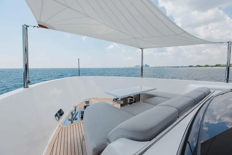Chameleon Yacht Photos Pics Luxurious 2024 Sanlorenzo SL90A yacht deck with seating, table, and ocean view.