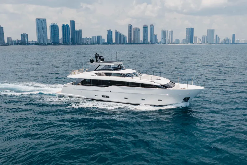 Chameleon Yacht Photos Pics Luxury 2024 Sanlorenzo SL90A yacht cruising near city skyline on open water.