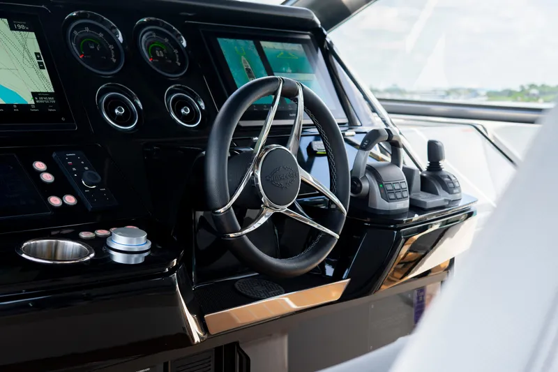  Yacht Photos Pics 2024 Sunseeker Superhawk 55 yacht helm with advanced navigation controls and sleek design.