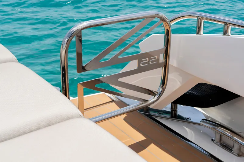  Yacht Photos Pics 2024 Sunseeker Superhawk 55 yacht detail with sleek railing and ocean backdrop.