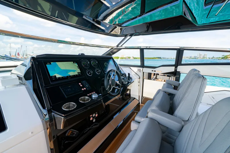  Yacht Photos Pics 2024 Sunseeker Superhawk 55 yacht cockpit with modern navigation system and luxurious seating.