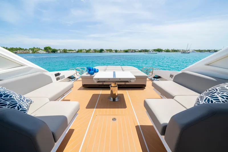  Yacht Photos Pics Luxurious 2024 Sunseeker Superhawk 55 yacht deck with elegant seating, overlooking serene blue waters.