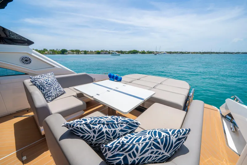  Yacht Photos Pics Luxurious 2024 Sunseeker Superhawk 55 yacht deck with stylish seating and ocean view.