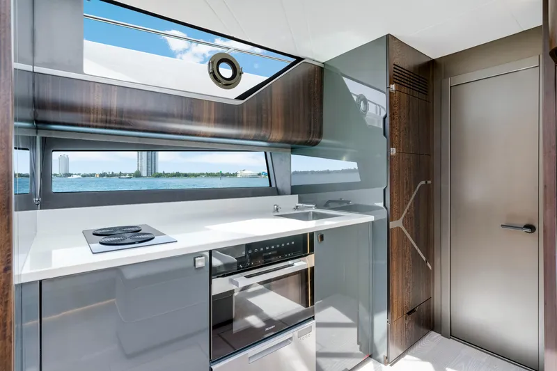  Yacht Photos Pics Modern kitchen interior of 2024 Sunseeker Superhawk 55 yacht with sleek design and ocean view.