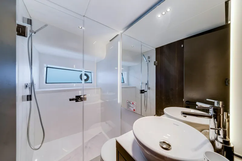  Yacht Photos Pics Luxurious bathroom in 2024 Sunseeker Superhawk 55 yacht, featuring modern fixtures and sleek design.