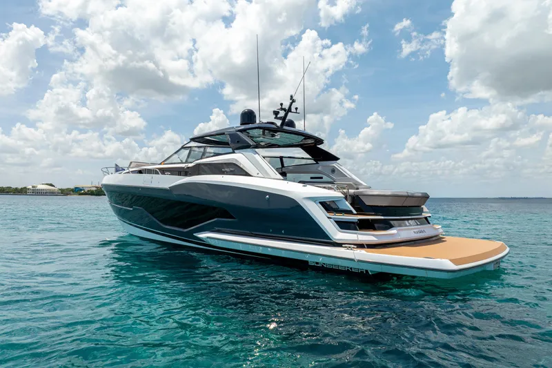  Yacht Photos Pics 2024 Sunseeker Superhawk yacht on clear blue water under a partly cloudy sky.