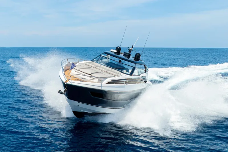  Yacht Photos Pics 2024 Sunseeker Superhawk yacht cruising on open sea, creating dynamic water splashes.